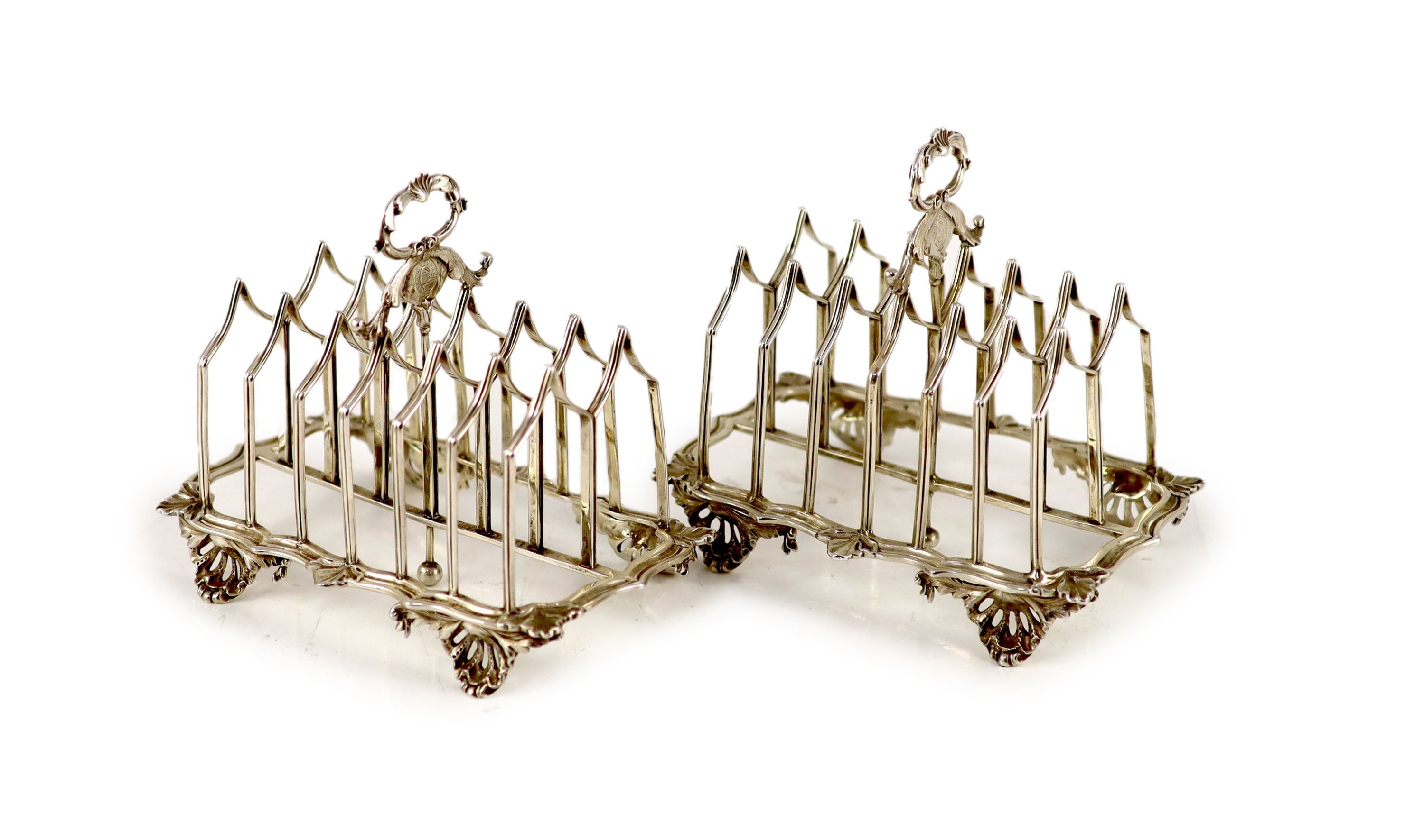 A pair of William IV silver gothic style seven bar toastracks, by Charles Fox II